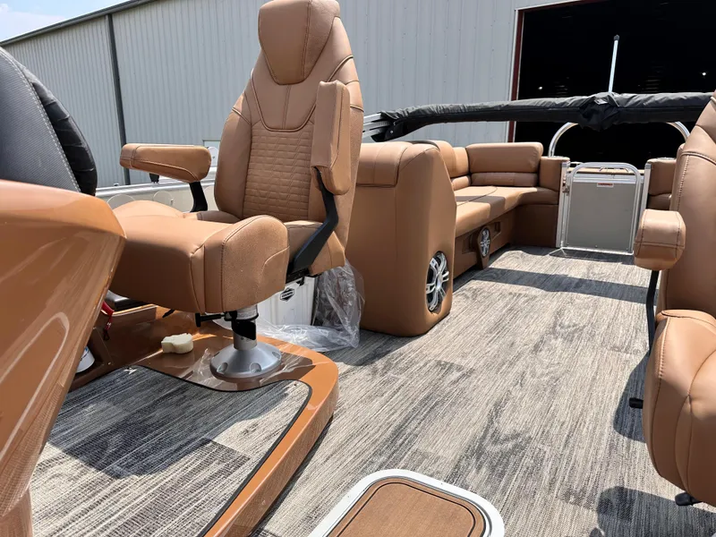Slide: The Image of 2023 Avalon Catalina Quad Lounger 25 interior with tan leather seats and gray carpet. - 10
