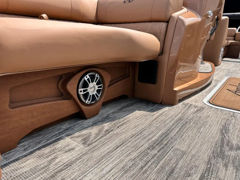 Slide: The Image of 2023 Avalon Catalina Quad Lounger 25 interior, featuring luxurious seating and built-in speaker. - 11