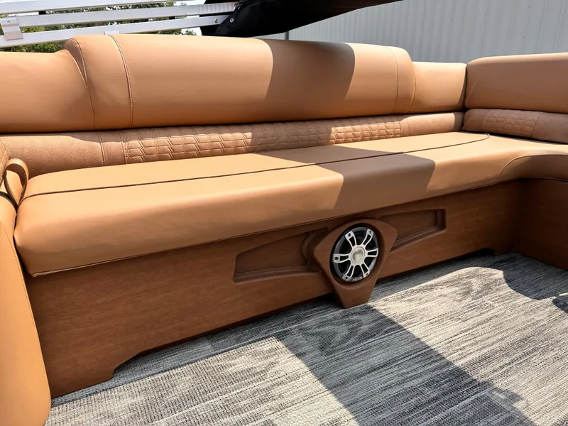 Slide: The Image of 2023 Avalon Catalina Quad Lounger 25 interior seating with built-in speaker. - 12