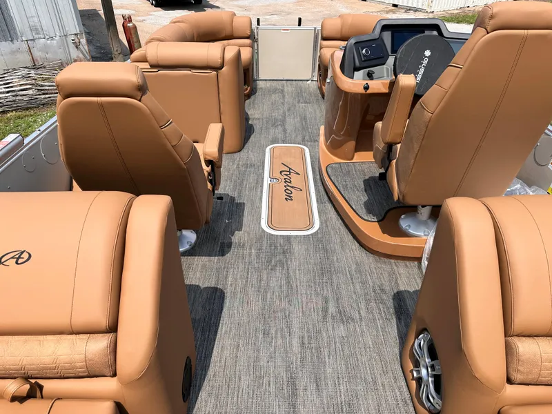 Slide: The Image of 2023 Avalon Catalina Quad Lounger 25 interior with tan leather seats and modern dashboard. - 6