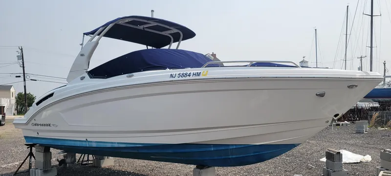 The Image of 2018 Chaparral 257 SSX boat on dry dock with blue cover. - 0