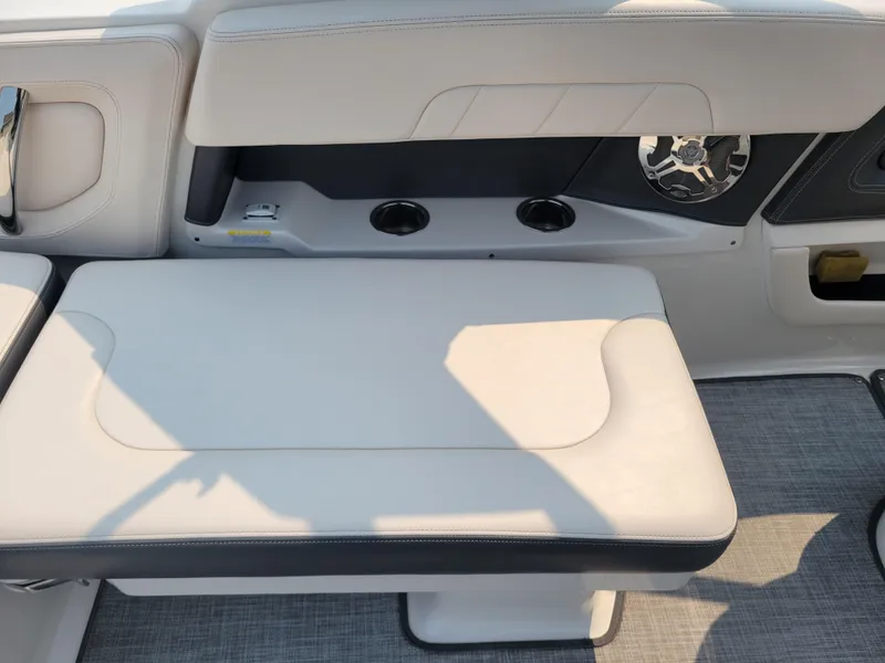 Slide: The Image of 2018 Chaparral 257 SSX boat interior seating with cup holders and speaker. - 17