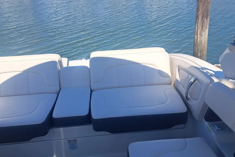 Slide: The Image of 2018 Chaparral 257 SSX boat interior with white seating by the water. - 26