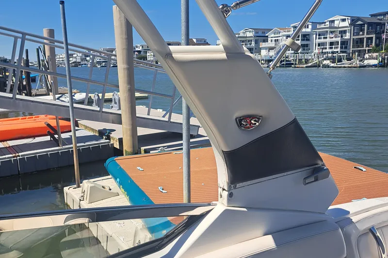 Slide: The Image of 2018 Chaparral 257 SSX boat docked at a marina with waterfront buildings. - 27