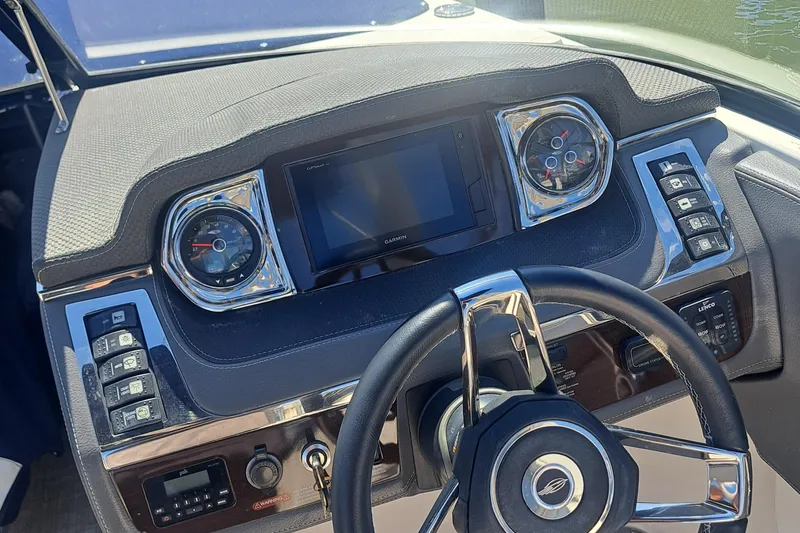 Slide: The Image of 2018 Chaparral 257 SSX boat dashboard with steering wheel and control panel. - 28