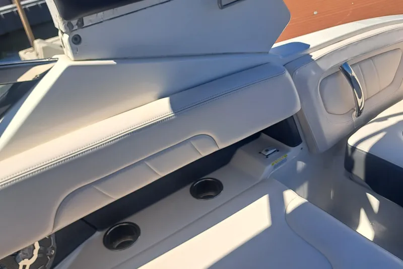 Slide: The Image of 2018 Chaparral 257 SSX boat interior with white seating and cup holders. - 32