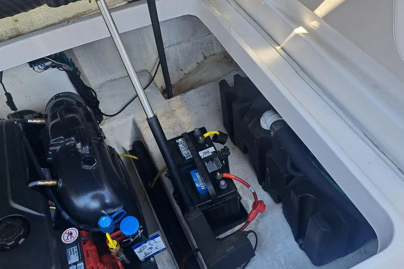 Slide: The Image of Engine compartment of 2018 Chaparral 257 SSX boat showing battery and components. - 34