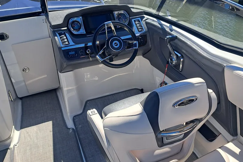 Slide: The Image of 2018 Chaparral 257 SSX boat cockpit with steering wheel and control panel. - 36