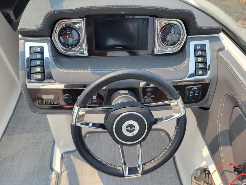Slide: The Image of 2018 Chaparral 257 SSX boat dashboard with steering wheel and control panel. - 8