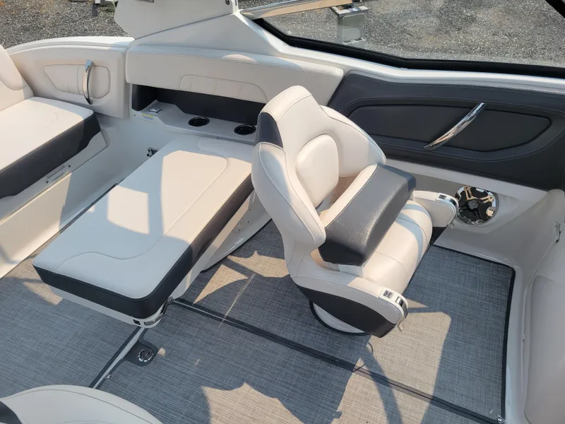 Slide: The Image of 2018 Chaparral 257 SSX boat interior with white and gray seating. - 9