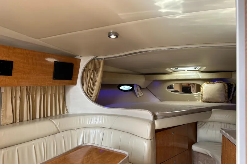 Slide: The Image of Luxurious interior of 2003 Regal 3260 Commodore yacht with elegant seating and wood accents. - 13