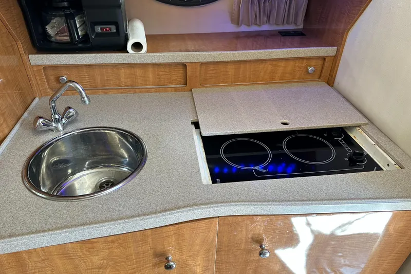 Slide: The Image of 2003 Regal 3260 Commodore kitchen with sink and electric stove. - 16