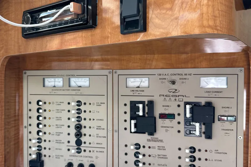 Slide: The Image of 2003 Regal 3260 Commodore control panel with switches and gauges. - 22