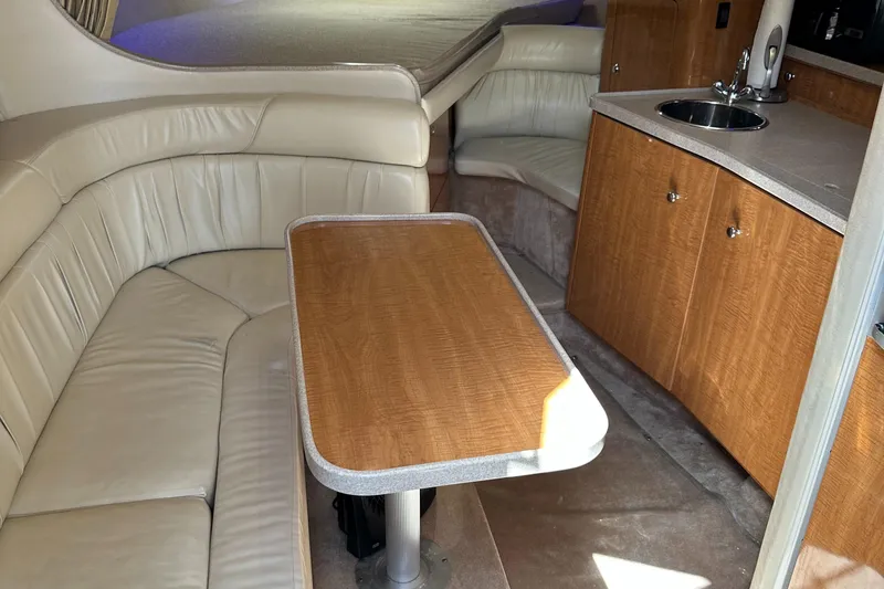 Slide: The Image of Interior of 2003 Regal 3260 Commodore yacht with seating and kitchenette. - 23