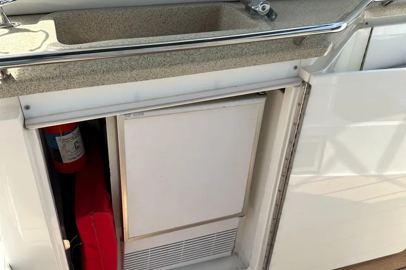 Slide: The Image of 2003 Regal 3260 Commodore boat kitchenette with sink and storage. - 24