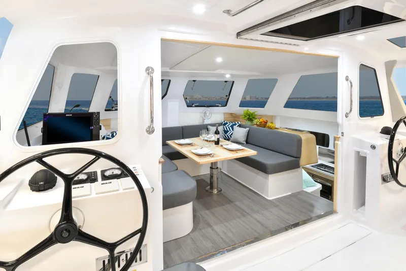 Slide: The Image of Interior of 2025 Seawind 1170 catamaran with modern seating and dining area. - 16