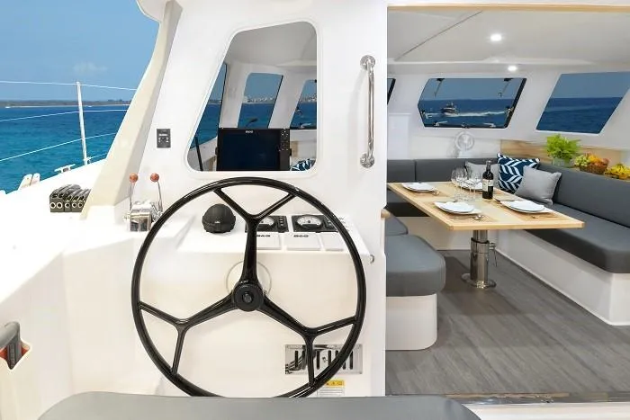 Slide: The Image of Interior of 2025 Seawind 1170 catamaran with helm and dining area. - 17