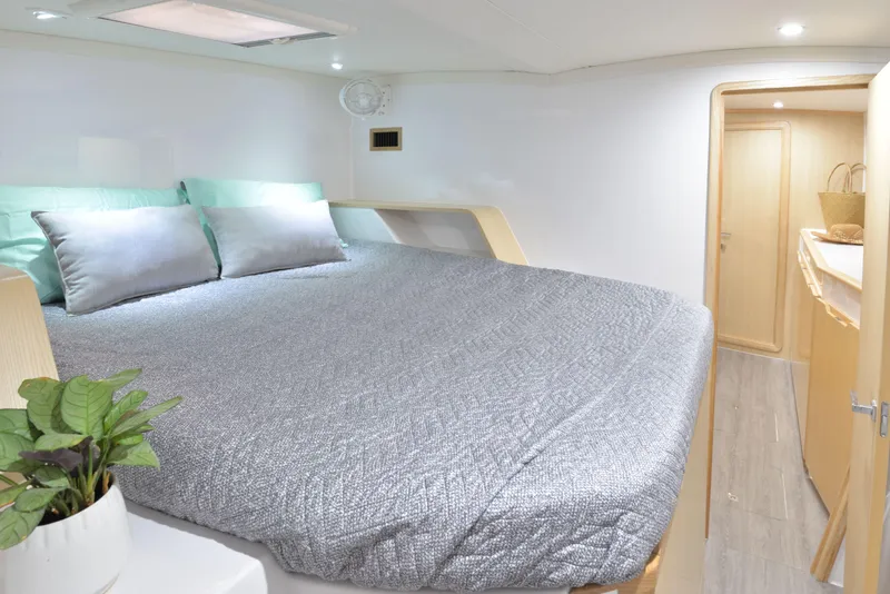 Slide: The Image of 2025 Seawind 1170 yacht bedroom with modern decor and natural light. - 25