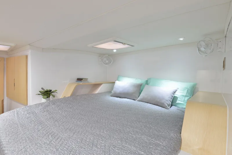 Slide: The Image of Modern bedroom interior of Seawind 1170 yacht, 2025 model, with cozy bed and soft lighting. - 26