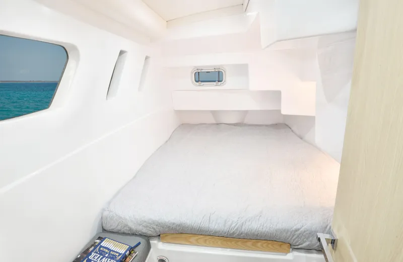 Slide: The Image of Seawind 1170 2025 model cabin interior with bed and ocean view. - 33