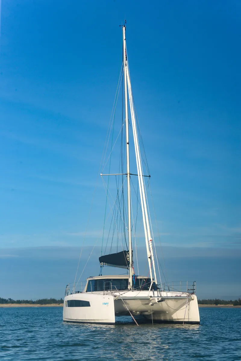 Slide: The Image of 2025 Seawind 1170 catamaran sailing on calm waters under a clear blue sky. - 8