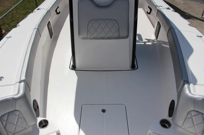 Slide: The Image of 2023 Blue Wave 2600 Makaira boat interior with cushioned seating and storage compartments. - 11