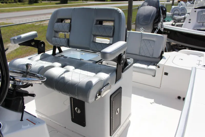 Slide: The Image of 2023 Blue Wave 2600 Makaira boat with cushioned seating and steering console. - 12