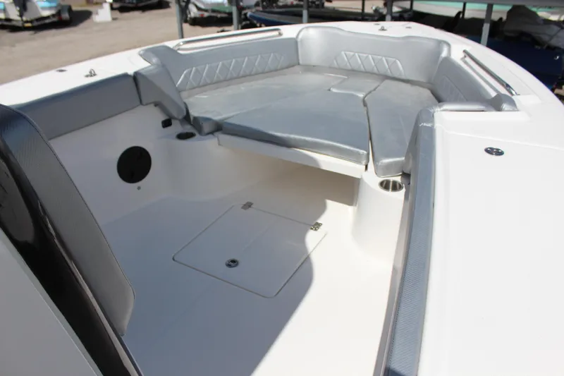 Slide: The Image of 2023 Blue Wave 2600 Makaira boat interior with cushioned seating and storage compartments. - 14