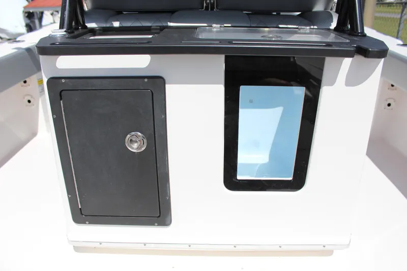 Slide: The Image of 2023 Blue Wave 2600 Makaira boat console with storage compartment and window. - 16