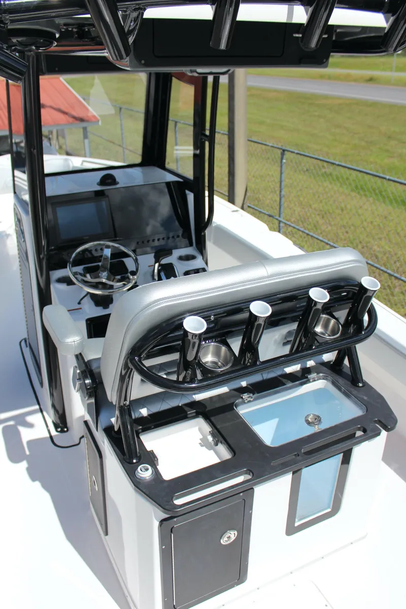 Slide: The Image of 2023 Blue Wave 2600 Makaira boat console with rod holders and navigation equipment. - 19