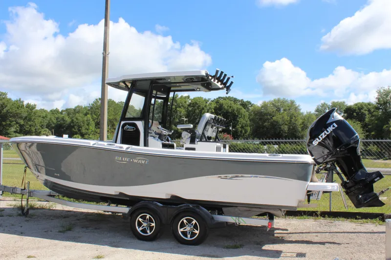 Slide: The Image of 2023 Blue Wave 2600 Makaira boat on trailer with Suzuki outboard motor. - 2