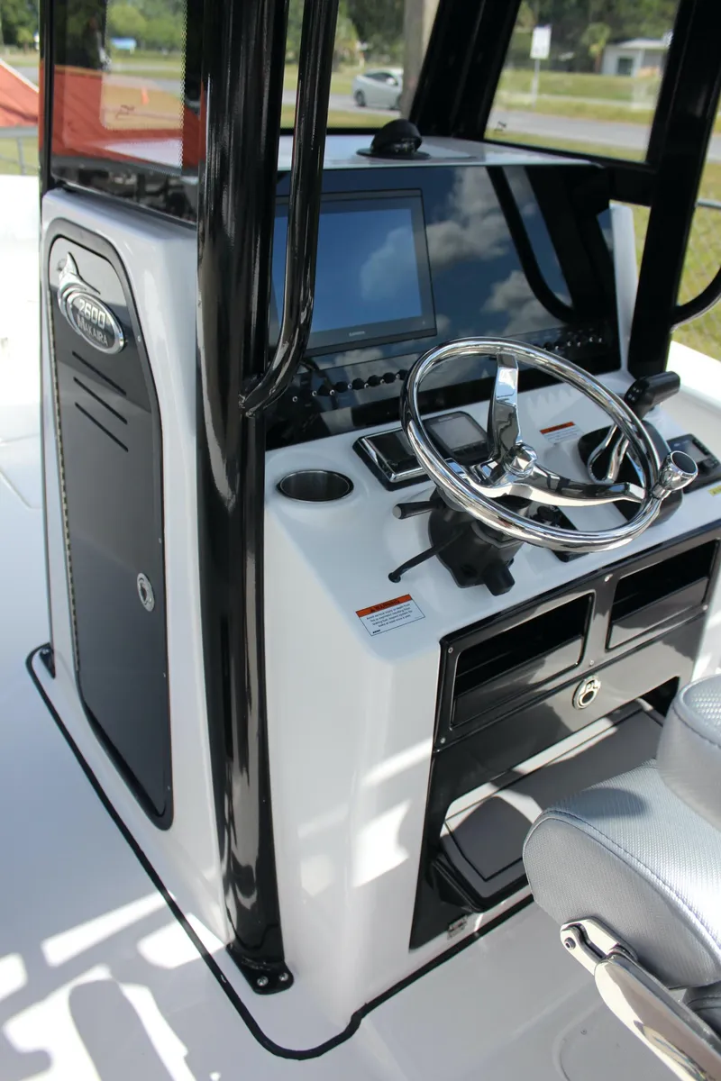 Slide: The Image of 2023 Blue Wave 2600 Makaira boat console with steering wheel and navigation system. - 22