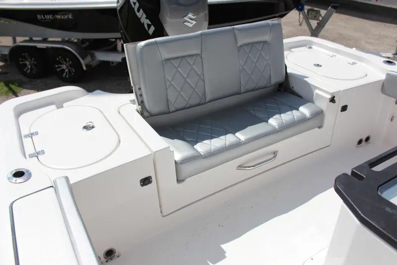 Slide: The Image of 2023 Blue Wave 2600 Makaira boat with cushioned seating and storage compartments. - 7