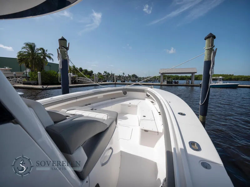 Slide: The Image of 2023 Regulator 41 boat docked at a marina on a sunny day. - 12