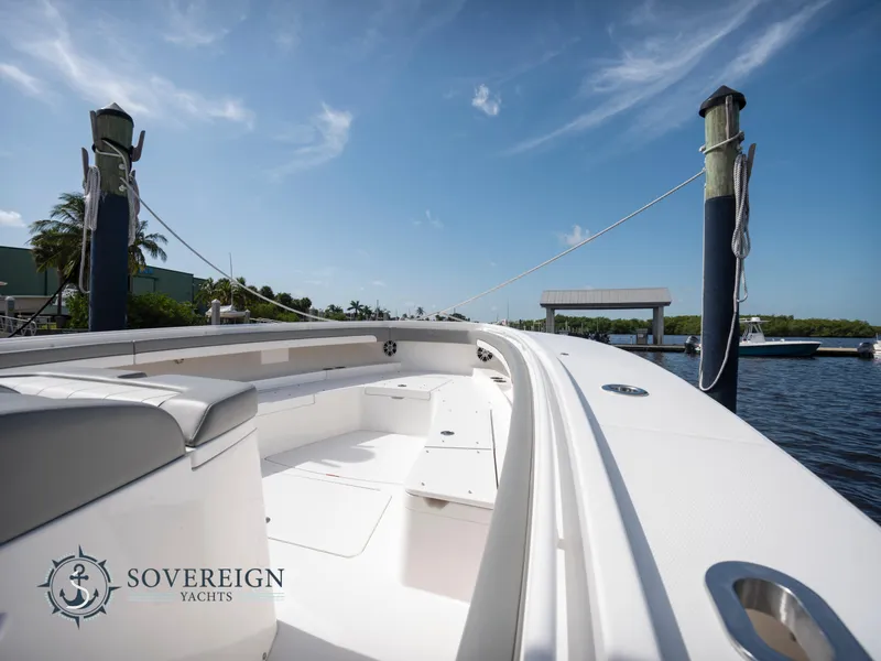 Slide: The Image of 2023 Regulator 41 yacht docked at a marina under a clear blue sky. - 13