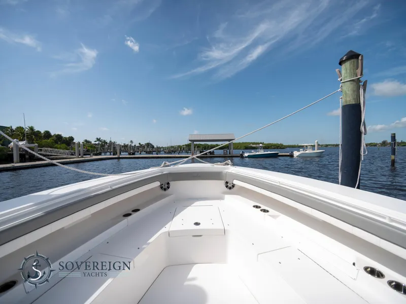 Slide: The Image of 2023 Regulator 41 yacht docked at a marina under a clear blue sky. - 14