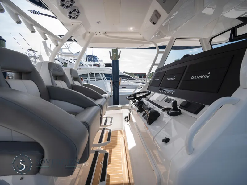 Slide: The Image of 2023 Regulator 41 boat cockpit with advanced Garmin navigation system and luxurious seating. - 21