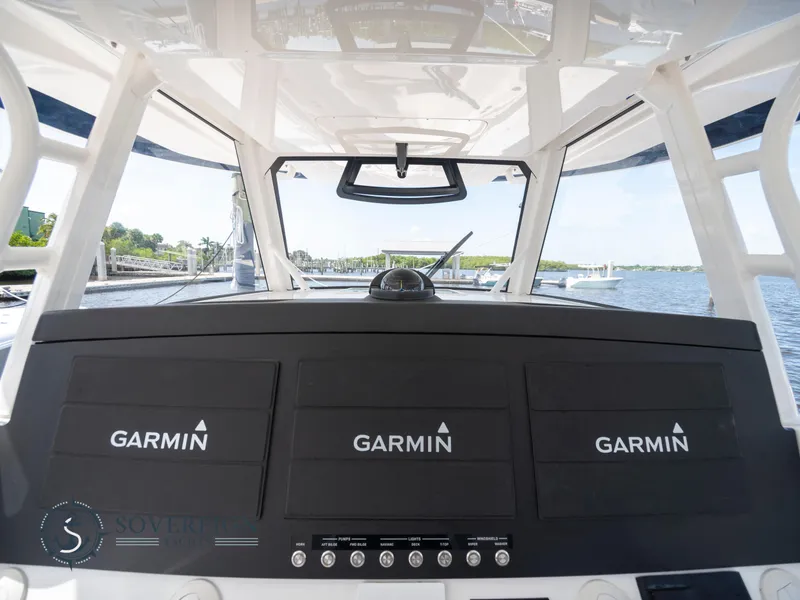 Slide: The Image of 2023 Regulator 41 boat dashboard with Garmin navigation screens. - 23