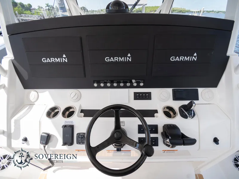 Slide: The Image of 2023 Regulator 41 yacht helm with Garmin navigation displays and Sovereign Yachts logo. - 24