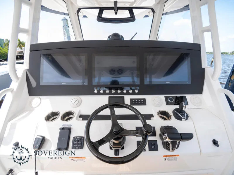 Slide: The Image of 2023 Regulator 41 yacht helm with advanced navigation system and controls. - 29