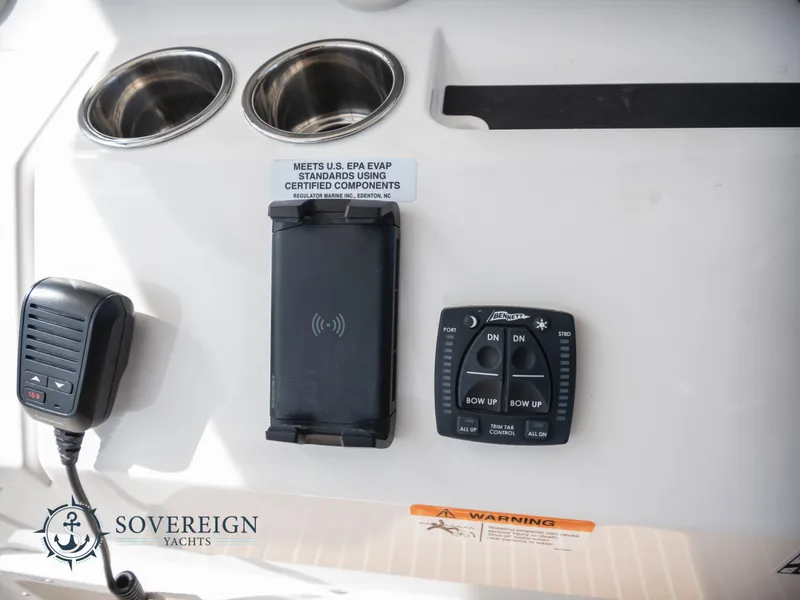 Slide: The Image of Control panel of a 2023 Regulator 41 yacht with cup holders and microphone. - 31