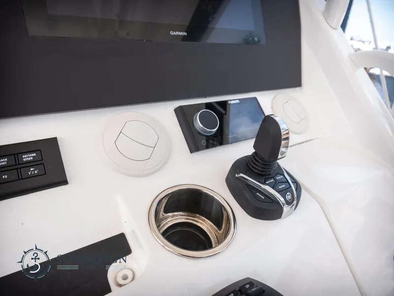 Slide: The Image of Control panel of 2023 Regulator 41 boat with joystick and cup holder. - 33