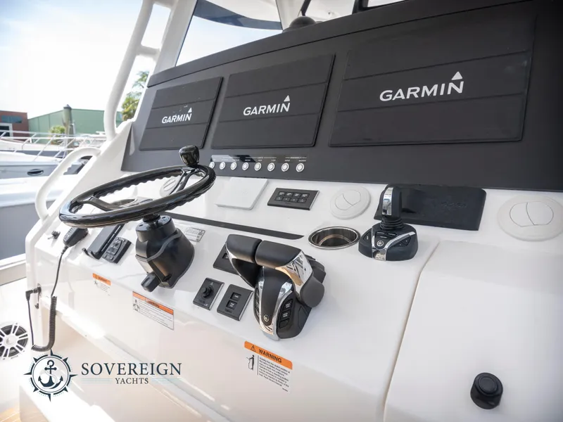Slide: The Image of 2023 Regulator 41 yacht helm with Garmin navigation systems. Sovereign Yachts branding. - 37