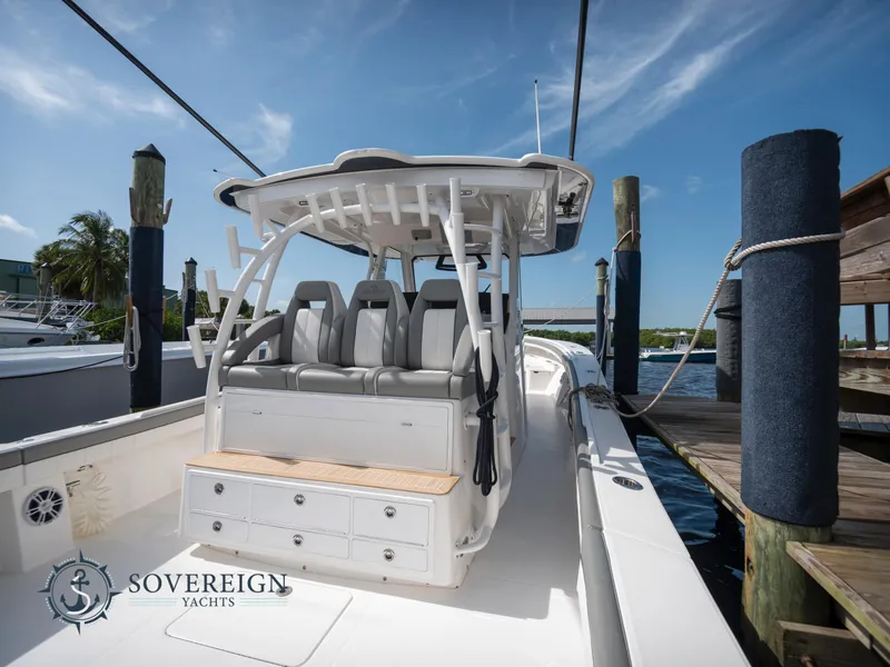 Slide: The Image of 2023 Regulator 41 boat docked, featuring spacious seating and storage. Sovereign Yachts branding visible. - 7