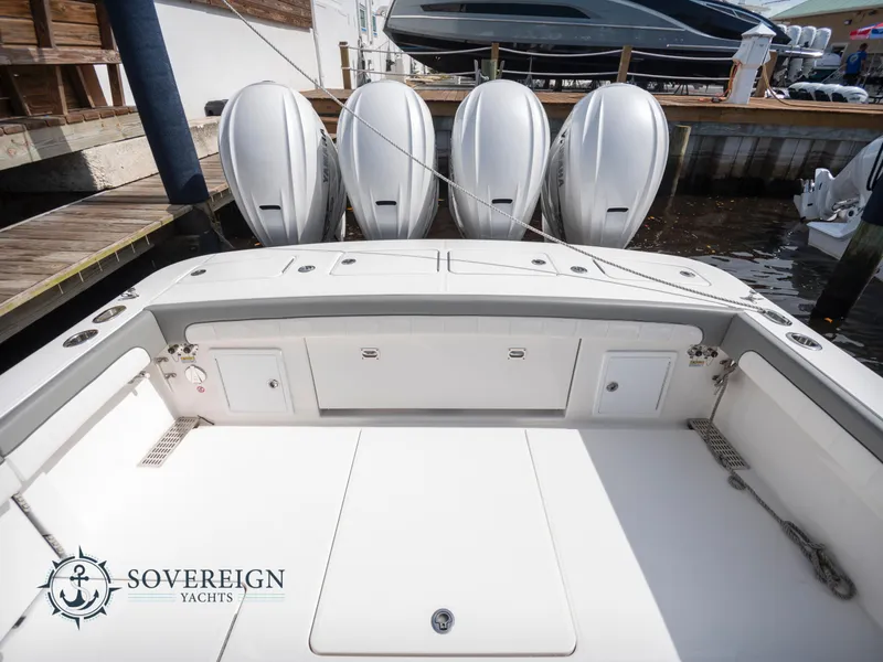 Slide: The Image of 2023 Regulator 41 boat with quad outboard engines at dock, Sovereign Yachts logo. - 8
