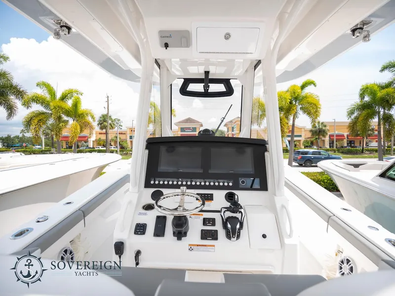 Slide: The Image of 2023 Regulator 34 boat helm station with advanced navigation controls, displayed by Sovereign Yachts. - 17