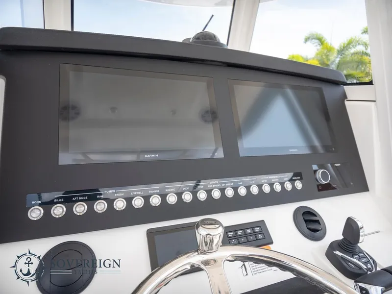 Slide: The Image of 2023 Regulator 34 boat dashboard with dual screens and control panel. - 18