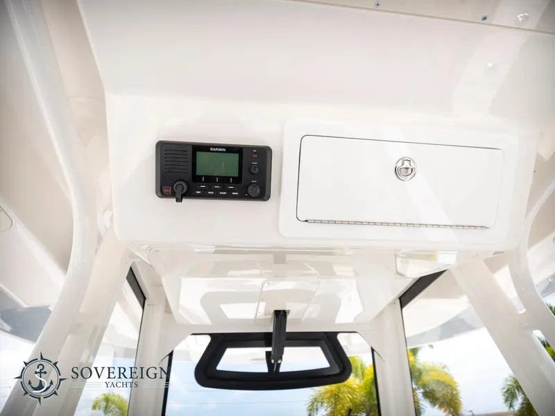 Slide: The Image of 2023 Regulator 34 boat interior with radio and storage compartment. - 25