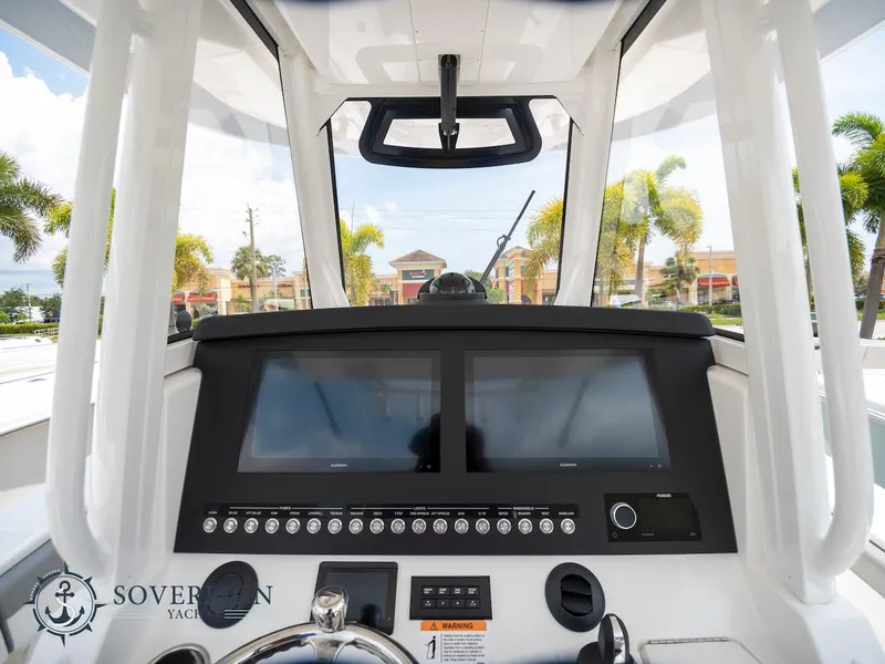 Slide: The Image of 2023 Regulator 34 boat dashboard with dual screens and control panel. - 26
