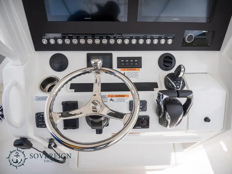 Slide: The Image of 2023 Regulator 34 boat helm with steering wheel and controls. - 28